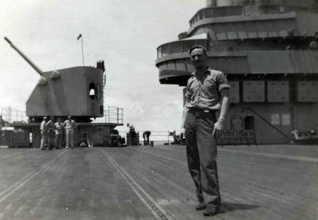 Gene Ellis Buettner on the deck of the Boxer during the Korean War in front of the 5-inch guns.