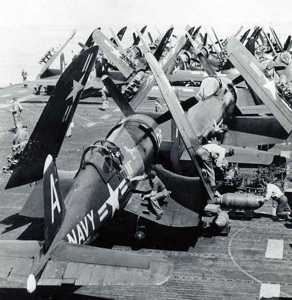 Chance Vought F4U Corsair and - are lined up the deck of the USS Boxer.