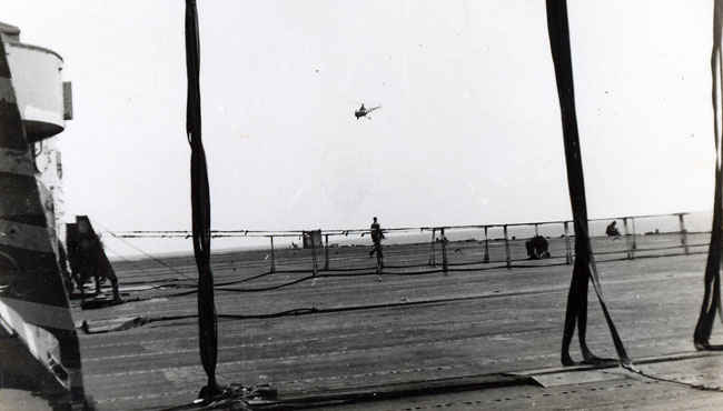 A special cargo net is set for when F9F Panther jets are about to land.