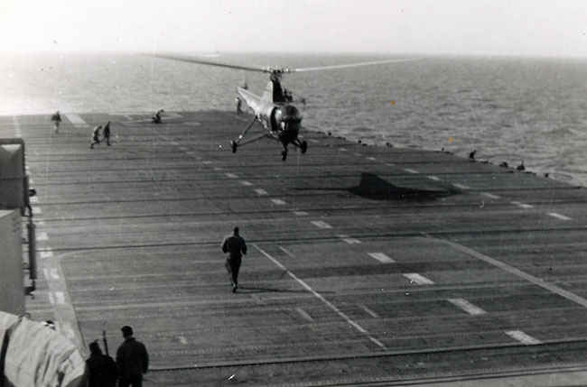 A helicopter would always take off and patrol the water around the USS Boxer during the Korean War when planes were going to land or take off. The reason for this is so that it could pick up any pilots who had to bailout. As you can tell this was a common occurrence during the 1950's.