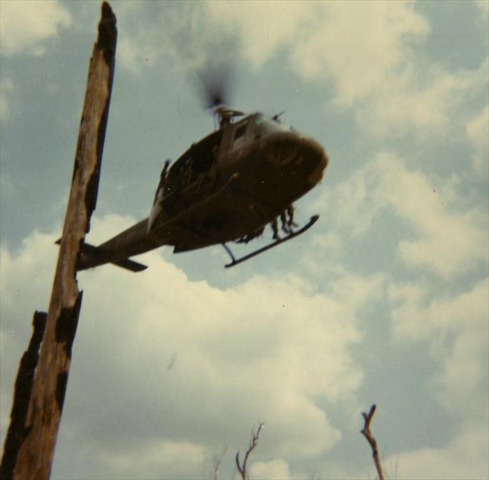 Huey landing in Vietnam to drop off soldiers and supplies.