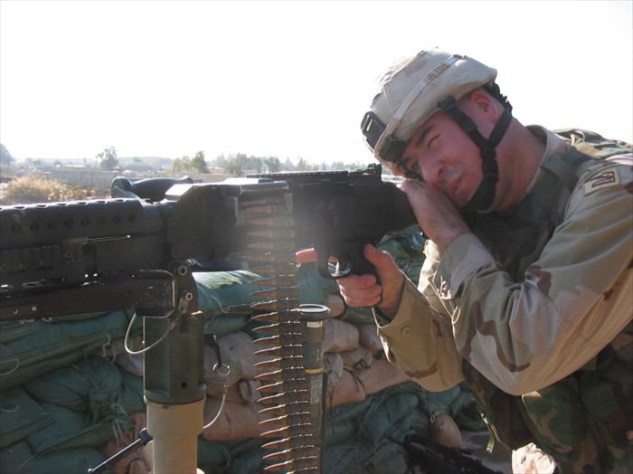 Pic of me manning the 240B Machine Gun providing overwatch, as a military convoy enters the main gate.