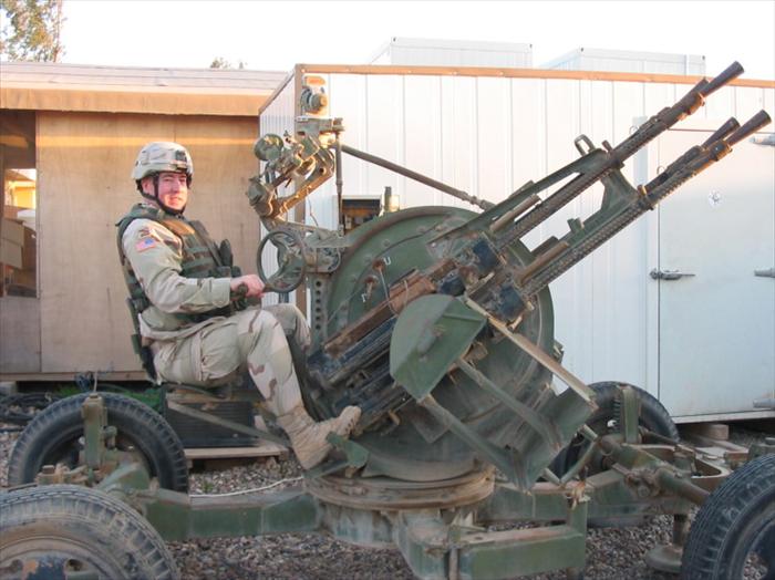 Photo op; me sitting on an old Russian-made, Photo op; me sitting on an old Russian-made, quad machine guns-AAA (Anti Aircraft Artillery) weapon system.