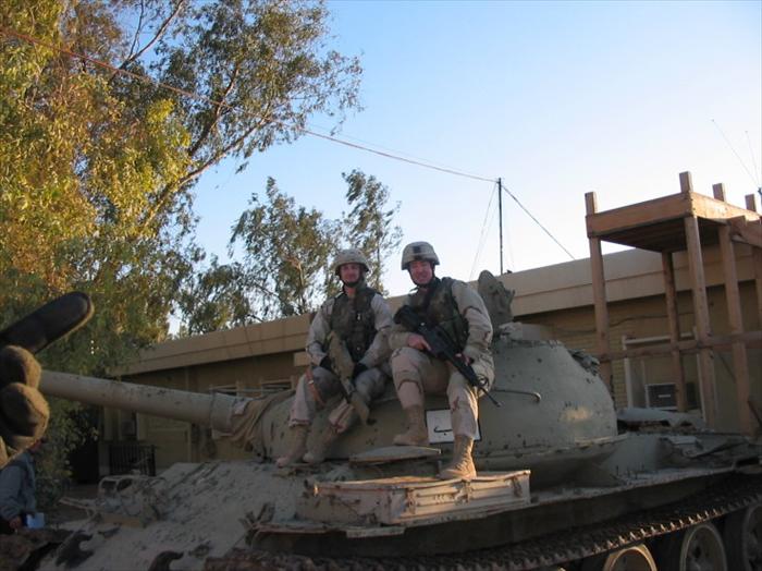 Specialist Dickerson and I posing on a T-55 Russian tank in front of our Battalion HQ.