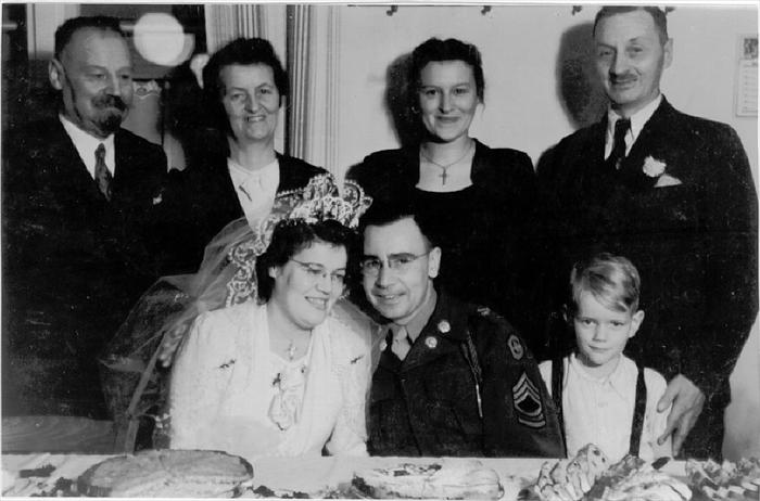 My Oma & Grandfather at their wedding reception.  Behind them from left-to-right, is my Great-Grandfather, Great-Grandmother, my Aunt Anneliese, and an unknown friend with child, circa 1948.